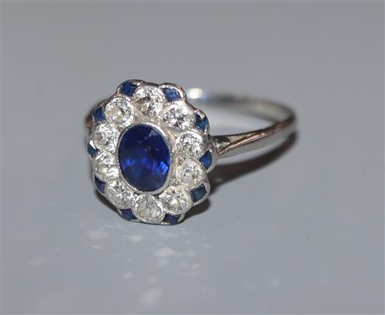 A sapphire and diamond cluster ring, white metal setting, size M.